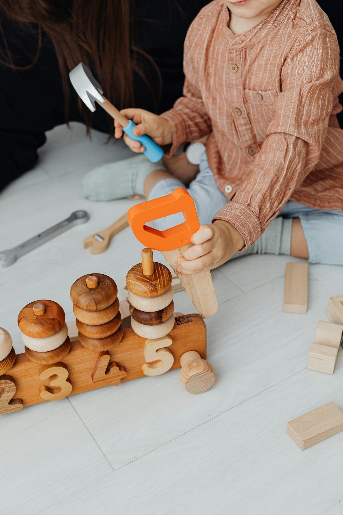 Child playing with educational wooden toys